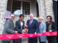 President Barchi holds the ribbon for Phoebe Haddon, chancellor of Rutgers University–Camden, to cut at the new Writers House in Camden